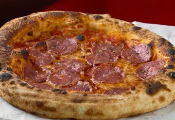 Salami Milano Pizza topped with salami, mozzarella, tomato sauce, extra virgin olive oil, and Grana Padano at Te’Amo Gastro &amp; Bistro in Canggu.
